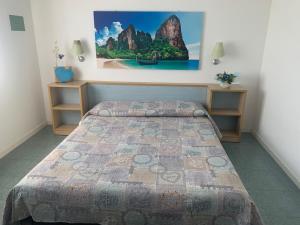 a bedroom with a bed and a painting on the wall at Casa del Sole in SantʼAndrea Apostolo dello Ionio