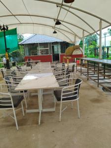 a group of tables and chairs under a tent at Dinosaur Resort Lonavala in Malavli