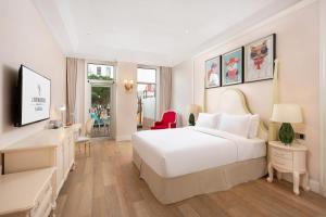a hotel room with a white bed and a desk at NARADA Resort Shanghai Hotel Disney Store in Shanghai