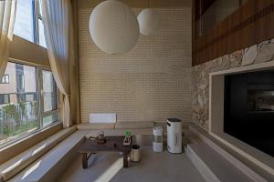 a living room with a couch and a fireplace at 无终隅民宿 in Jizhou