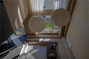 two lights in a room with a large window at 无终隅民宿 in Jizhou
