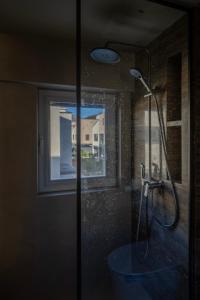 a shower in a bathroom with a glass door at 无终隅民宿 in Jizhou