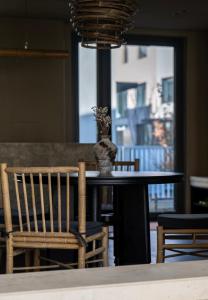 a table with a chair and a vase on it at 无终隅民宿 in Jizhou