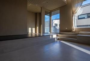 an empty room with a large window and wooden floors at 无终隅民宿 in Jizhou