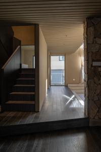 a staircase in a house with a stone wall at 无终隅民宿 in Jizhou