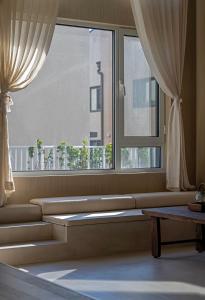 a living room with a large window and a table at 无终隅民宿 in Jizhou