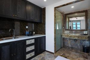 a kitchen with a sink and a mirror at The Nice Hotel Phu Quoc - Fireworks & Ocean view in Phu Quoc +71 photos