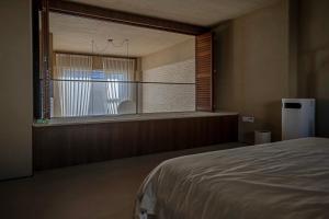 a room with a bed and a large window at 无终隅民宿 in Jizhou