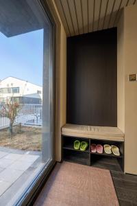 a room with a bench next to a large window at 无终隅民宿 in Jizhou