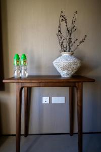 a wooden table with a vase on top of it at 无终隅民宿 in Jizhou