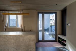 a kitchen with a large glass door to a balcony at 无终隅民宿 in Jizhou