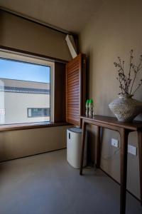 a living room with a large window and a table at 无终隅民宿 in Jizhou