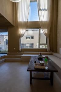 a living room with a table and a large window at 无终隅民宿 in Jizhou