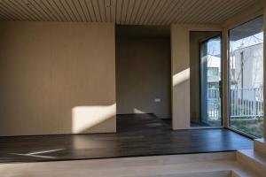 an empty room with a large window and wooden floors at 无终隅民宿 in Jizhou