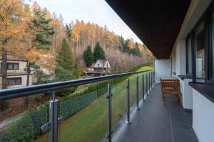 a balcony of a house with a view of a forest at Kurort Kozubnik Daglezja - Apartamenty Dream Apart in Porąbka
