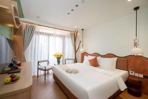 Postel nebo postele na pokoji v ubytování Me Saigon Boutique Hotel