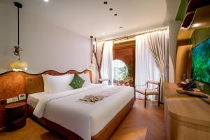 Postel nebo postele na pokoji v ubytování Me Saigon Boutique Hotel