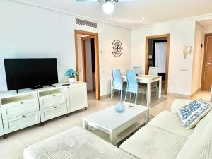 a living room with a couch and a tv at Valencia Beachfront Home 22 in Valencia
