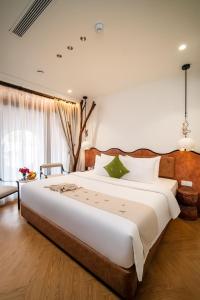 Postel nebo postele na pokoji v ubytování Me Saigon Boutique Hotel