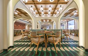 a dining room with a table and chairs at La Estoria, Goa - IHCL SeleQtions in Candolim