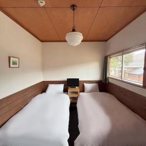 Postel nebo postele na pokoji v ubytování Guest House Vingt-Neuf 美好境界湯澤館