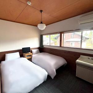 Postel nebo postele na pokoji v ubytování Guest House Vingt-Neuf 美好境界湯澤館