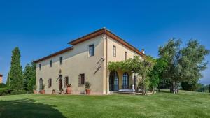 a large house with a large grass yard at Villa Marliana in Cerreto Guidi