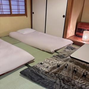 Postel nebo postele na pokoji v ubytování Guest House Vingt-Neuf 美好境界湯澤館