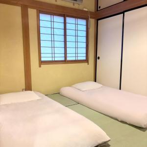 Postel nebo postele na pokoji v ubytování Guest House Vingt-Neuf 美好境界湯澤館