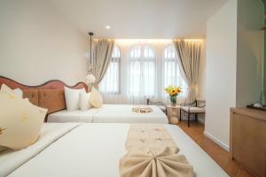 Postel nebo postele na pokoji v ubytování Me Saigon Boutique Hotel