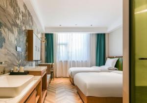 Letto o letti in una camera di Xiamen Airport SM City Plaza Yunrui Hotel