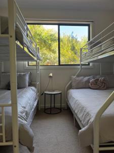 a bedroom with two bunk beds and a window at The Beach Haven - 4 bedroom Luxury Rye house Sleeps 12 in Rye