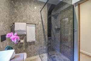 a bathroom with a shower with a glass door at Cornerstone Connection in Durban