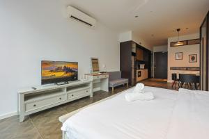 A television and/or entertainment centre at Borderless Swimming Pool - Invincible Twin Towers View - Free WiFi