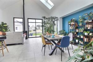 a living room with a table and chairs and a couch at Ty ar bleuenn in Penvénan