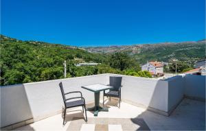 a table and two chairs on a balcony with a view at Nice Apartment In Zaton Veliki With Wifi in Zaton
