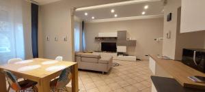 a kitchen and living room with a table and a couch at La piccola Flo in Terni