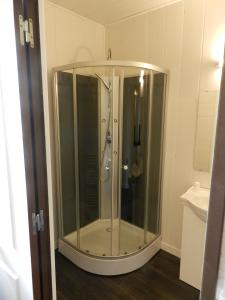 a shower with a glass enclosure in a bathroom at les chambres du parc in Dammarie-sur-Saulx