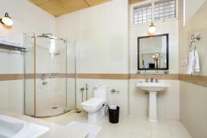a bathroom with a shower toilet and a sink at Koder House in Cochin