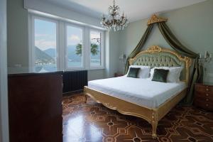 a bedroom with a large bed with a canopy at La Villa Regia in Torno