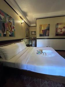 a bedroom with a large white bed in a room at Big Apple Dive Resort in Puerto Galera +24 photos