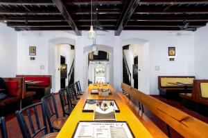 a dining room with a long table and chairs at Koder House in Cochin