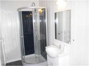 a white bathroom with a shower and a sink at les chambres du parc in Dammarie-sur-Saulx +1 photo