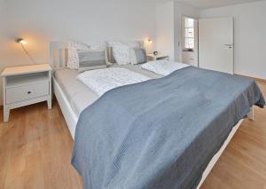 a bedroom with a large bed with a blue blanket at Alte Schmiede in Franken Vorstadt