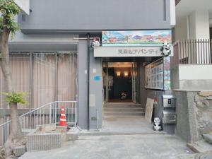 an entrance to a building with a sign on it at 天满橋 Home - elevator, suite room washmachine, kitchen 2 toilet 2 bathroom or 2 toilet 1 bathroom in Osaka