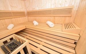 an empty wooden sauna with two white towels at Stunning Apartment In Rogoznica in Rogoznica