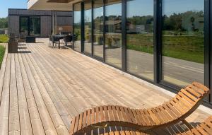 a wooden deck with two benches on top of a building at Amazing Home In Børkop With Wifi in Børkop +20 photos