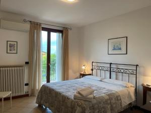 a bedroom with a bed and a large window at Al Vajo in Lazise
