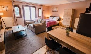 a hotel room with a bed and a living room at Guesthouse Pezodromos in Kalavrita