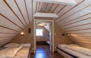 a room with two beds in a attic at Awesome Home In Drottningsskär With 2 Bedrooms in Drottningskär